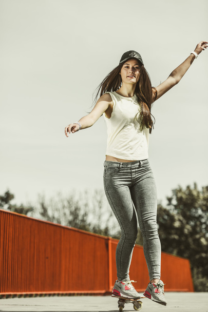 Teen girl skater riding skateboard on street. - Φωτογραφία, εικόνα