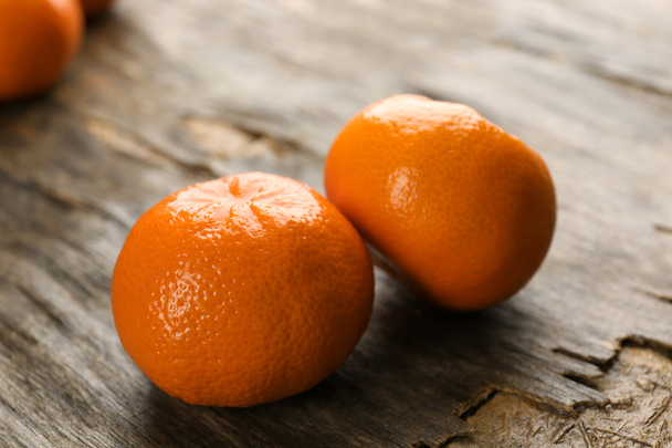 Fresh, delicious tangerines on a rustic table, close up - Fotó, kép