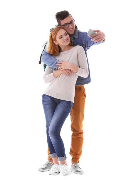 Young couple taking selfie with mobile phone isolated on white - Foto, Imagem