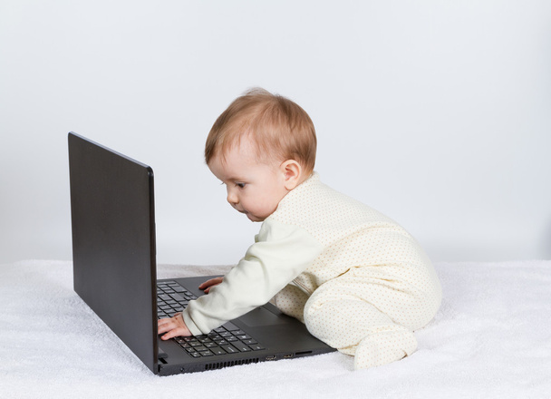 niedlicher kleiner Junge mit schwarzem Laptop - Foto, Bild