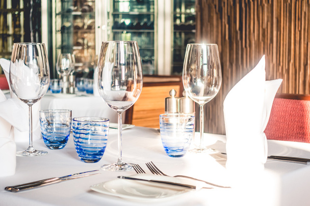 wine glasses with table setting - Фото, изображение