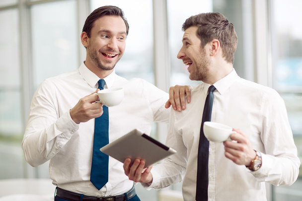 Cheerful business partners drinking coffee - Foto, Imagen