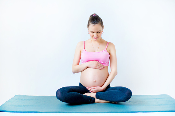 pregnant woman in lotus position - Foto, Imagen
