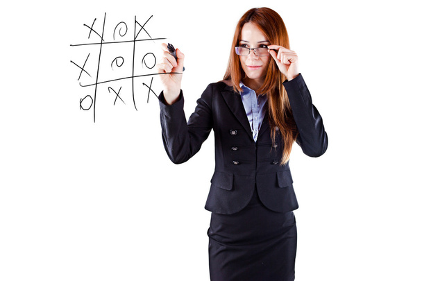 Young beautiful business woman tic-tac-toe game - 写真・画像
