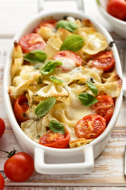 Casserole with farfalle pasta, cherry tomato, mozzarella cheese and herbs - Photo, Image