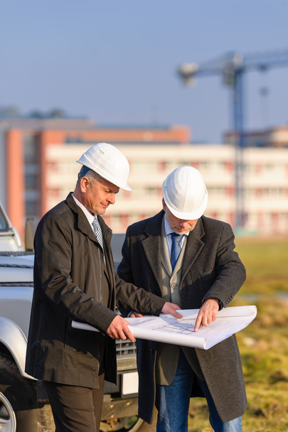 Two architects man look at construction plan - Fotografie, Obrázek