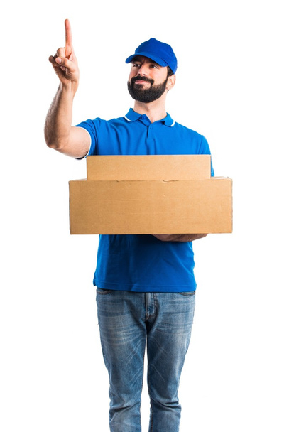Delivery man touching on transparent screen - Photo, Image