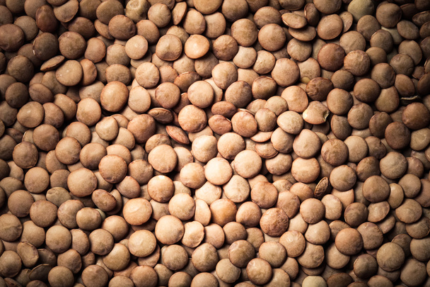 Orange lentil seeds as texture for background. Toned - Foto, immagini