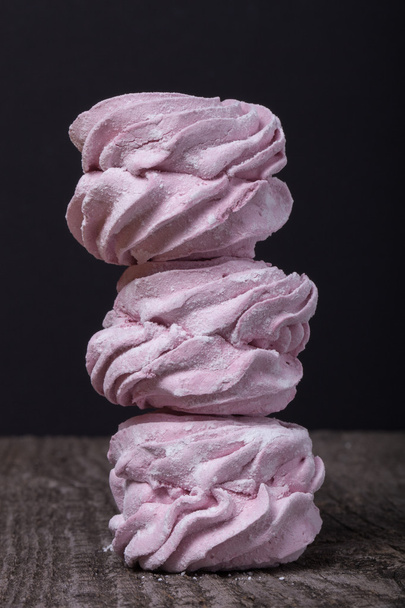Fresh pink homemade zephyr - marshmallow on old wooden table. Sh - 写真・画像
