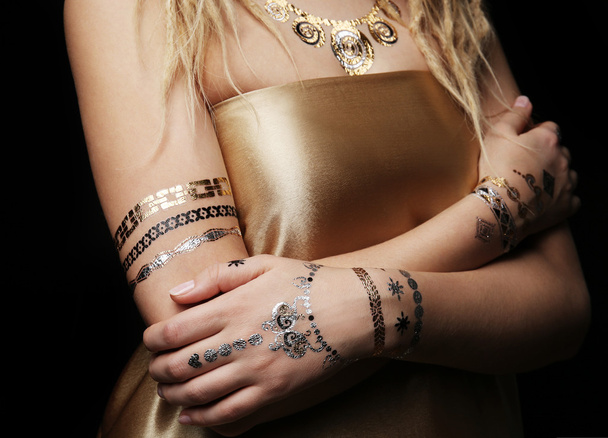 Young blonde girl tattoo   - 写真・画像