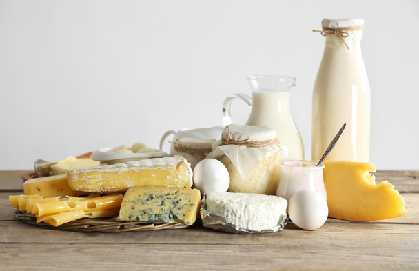 Set of fresh dairy products on wooden table, on white background - Photo, image