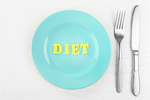 Blue plate with word diet on white table background - Photo, Image
