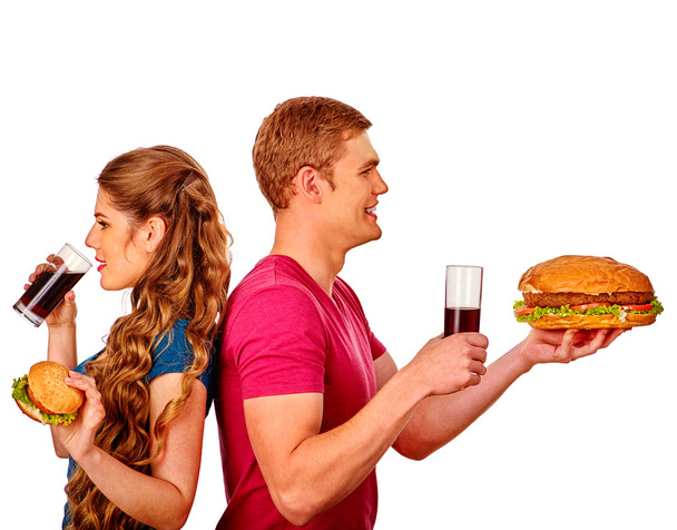 男と女のコーラで大きなサンドイッチを食べるします。分離されました。. - 写真・画像