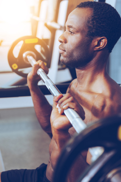 young African man working out on bench press - Foto, Bild