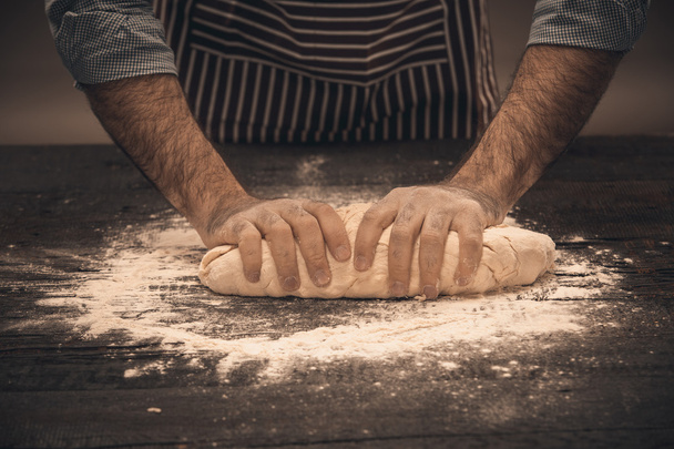 Male hands knead the dough. - Photo, Image