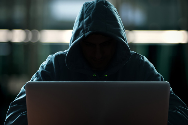 Hacker in front of his computer - Фото, изображение