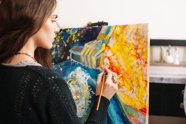Creative painter paints colorful picture. Closeup - Фото, изображение