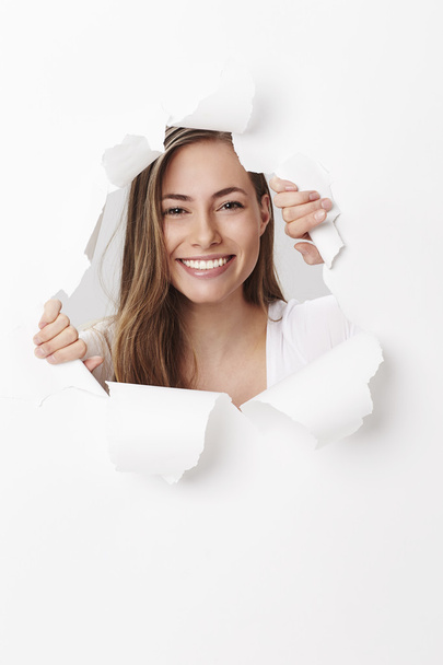 woman smiling through tears in paper - Foto, immagini