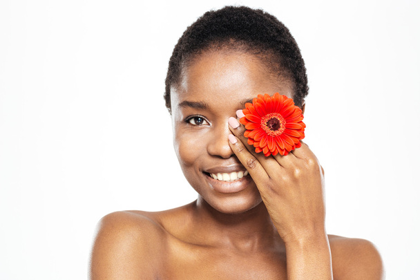 Smiling afro american woman posing with flower - Photo, Image