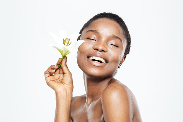 Smiling afro american woman holding flower  - Фото, зображення