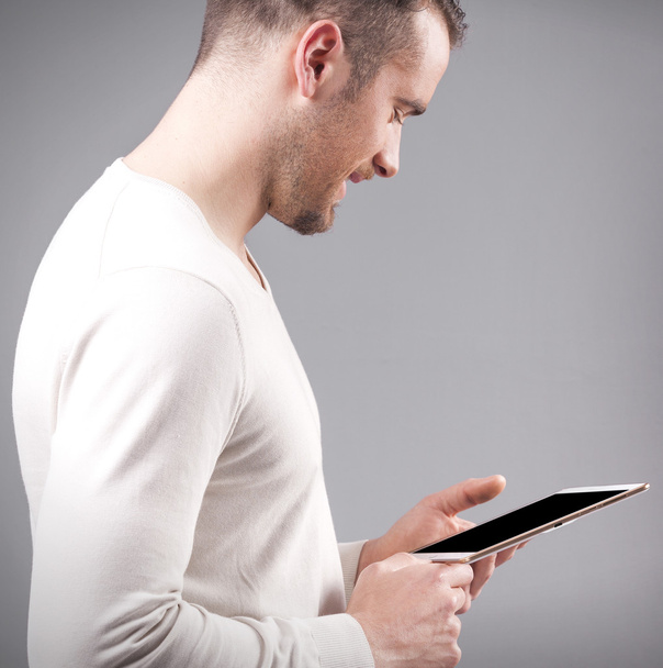 Handsome man holding a digital tablet - Foto, afbeelding
