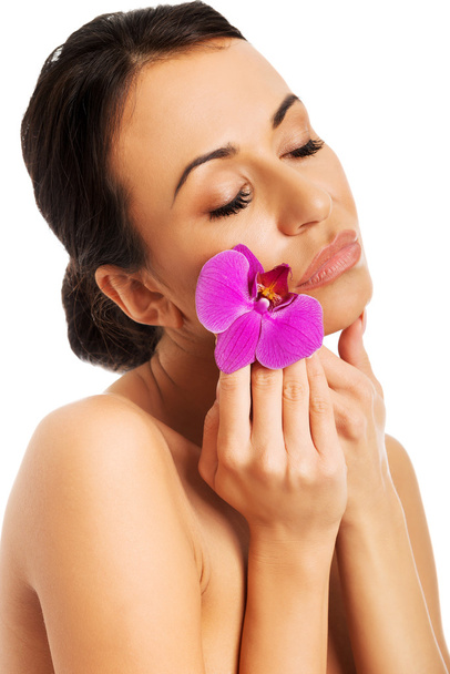 nő, lila orchidea és zárt szemek - Fotó, kép