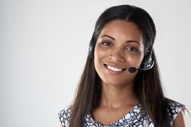 mixed race woman smiling with headset - Foto, Imagem