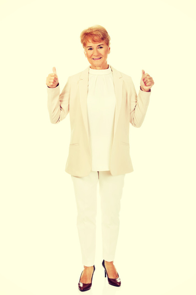 Smile elegant senior woman showing thumb up - Photo, image
