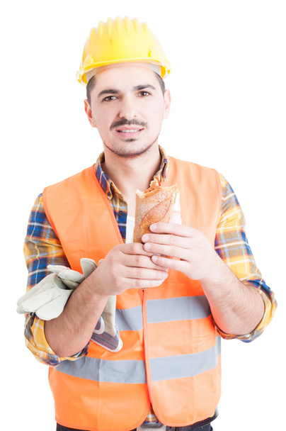 Lunch break concept with attractive engineer holding a sandwich - Fotografie, Obrázek
