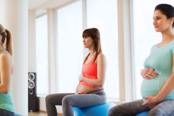 happy pregnant women exercising on fitball in gym - Fotoğraf, Görsel