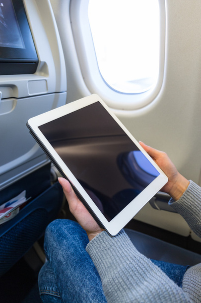 Woman using  tablet in airplane - Φωτογραφία, εικόνα