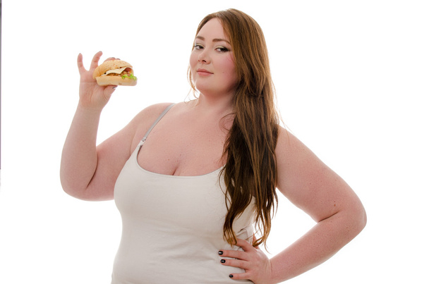 fat woman eating hamburger isolated on white background - Фото, изображение