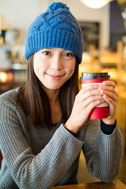 Woman with coffee cup at cafe - Photo, image
