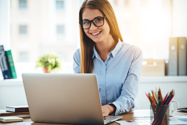 woman in glasses using laptop  - Фото, изображение