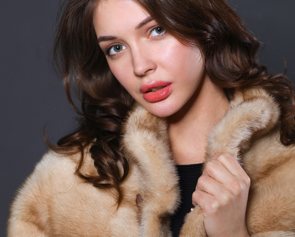 Portrait of a beautiful woman in  jacket with fur. - Photo, Image