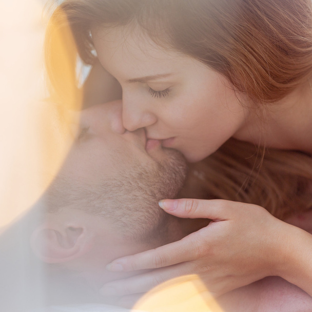 Amorous couple kissing tenderly - Фото, изображение