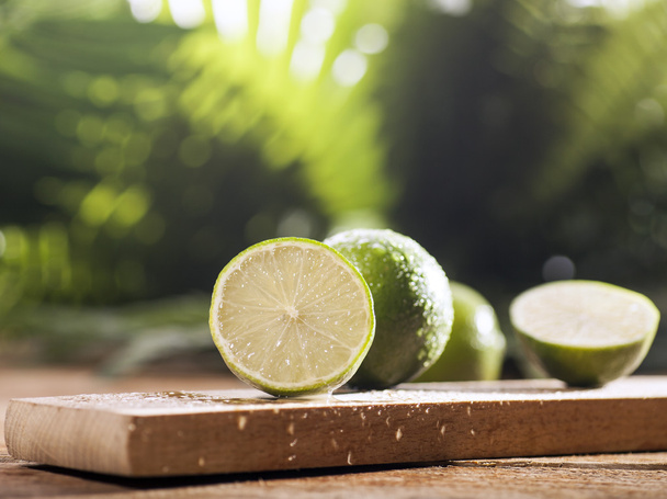 Fresh limes on wooden background - Fotó, kép