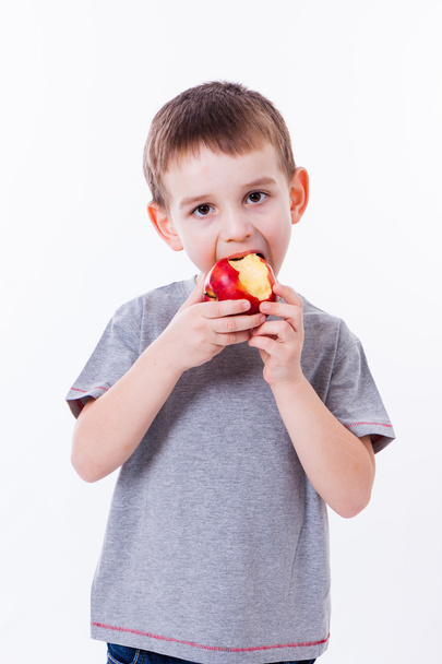 little boy with food isolated on white background - apple or a m - Фото, зображення