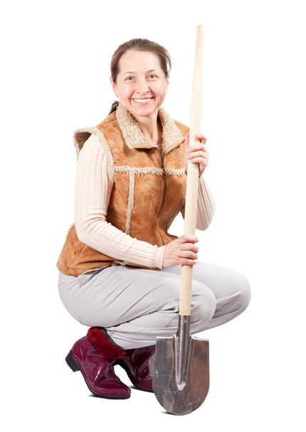 Woman sits with spade over white - Foto, Bild