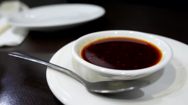 Hand taking some chili sauce inside Chinese restaurant - Кадры, видео