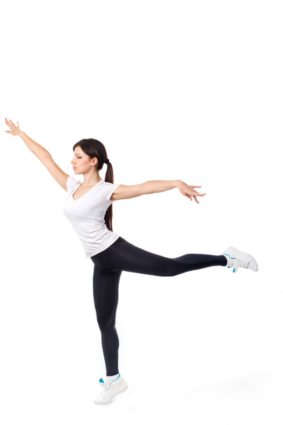 Pretty modern woman jumping dancing isolated on a white studio background - Фото, зображення