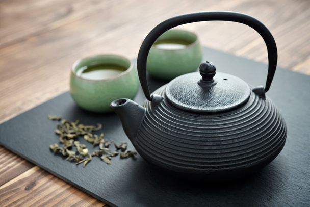 Green tea in cast-iron teapot - Fotó, kép