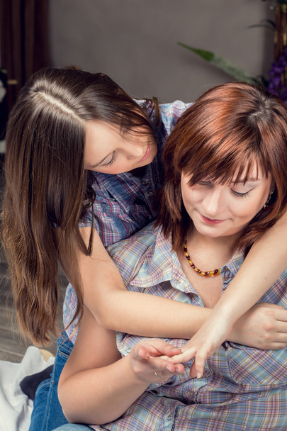 Beautiful young girl hugging her mother. - 写真・画像
