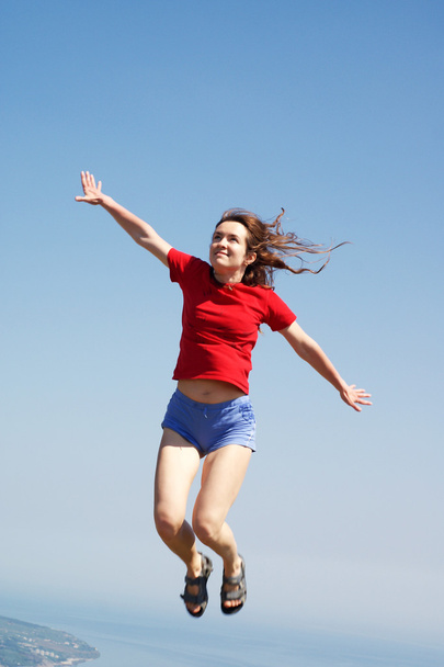 Woman is jumping in the sky - Photo, Image