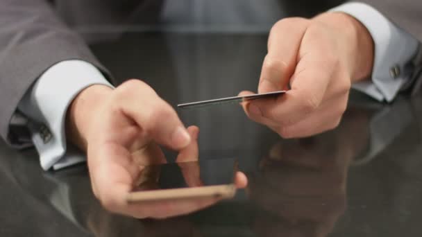 Boss using mobile banking on smartphone, inserting card number - Felvétel, videó