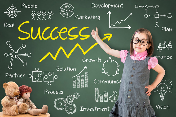 Cute little girl wearing business dress and showing success by many process on green chalk board. - 写真・画像