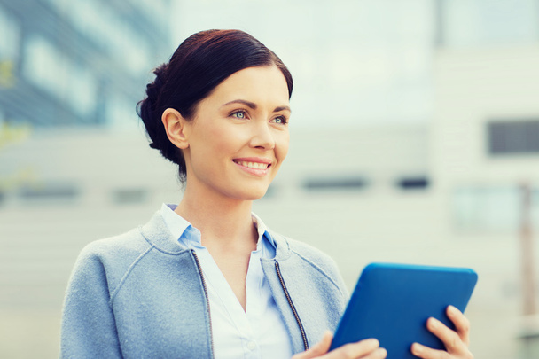 smiling business woman with tablet pc in city - Photo, Image