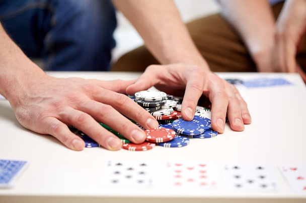 hands with casino chips making bet or taking win - Foto, imagen