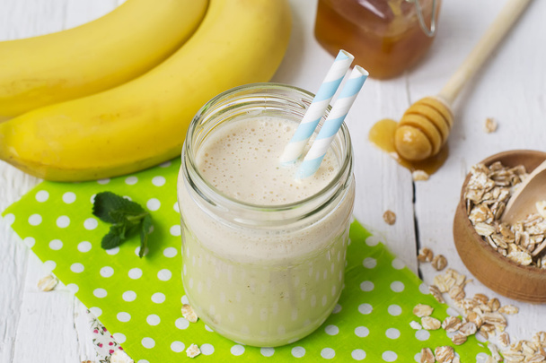 Banana smoothies in a glass jar on a white background - Photo, Image