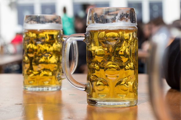two beer glasses in german biergarten background - Photo, Image